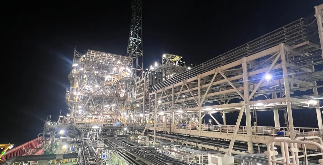 Process plant pipe racks and structures floodlit at night