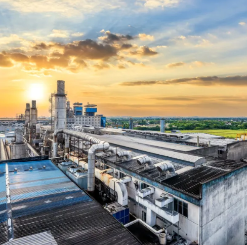 Ductwork and process plant on an industrial facility rooftop at sunset