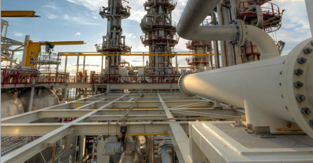 Large flanged pipeline and refinery process columns on a plant structure